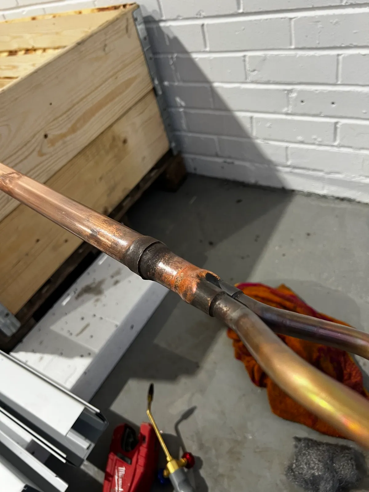 Copper pipework being brazed on site during a Clarus plumbing installation