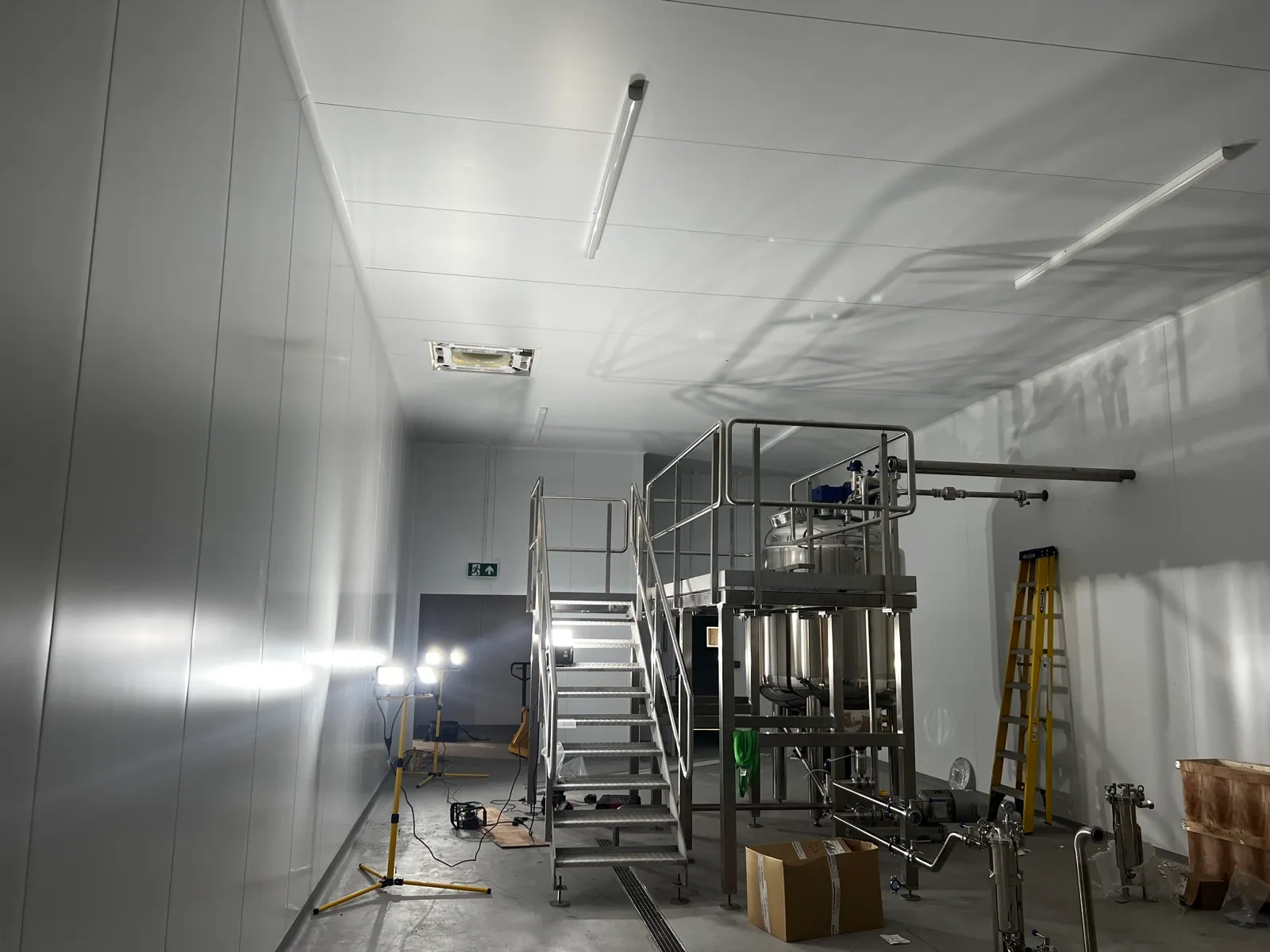A commercial plant room with stainless vessels, pipework and access platform installed by Clarus