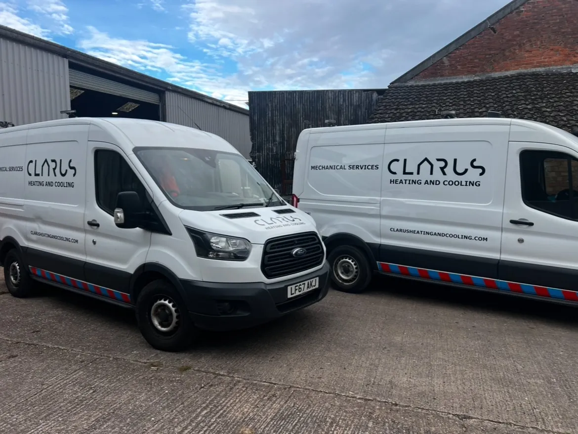 Two Clarus Heating & Cooling service vans outside the team's commercial unit