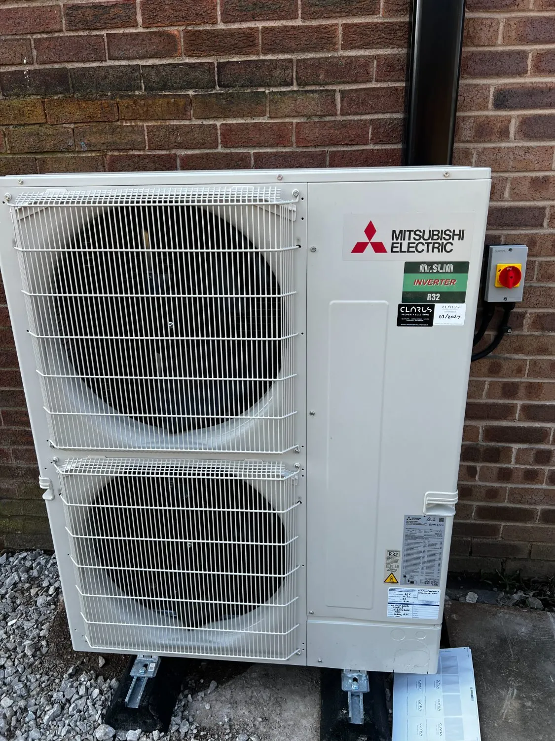 A Mitsubishi Electric condenser installed by Clarus, with the company's service sticker